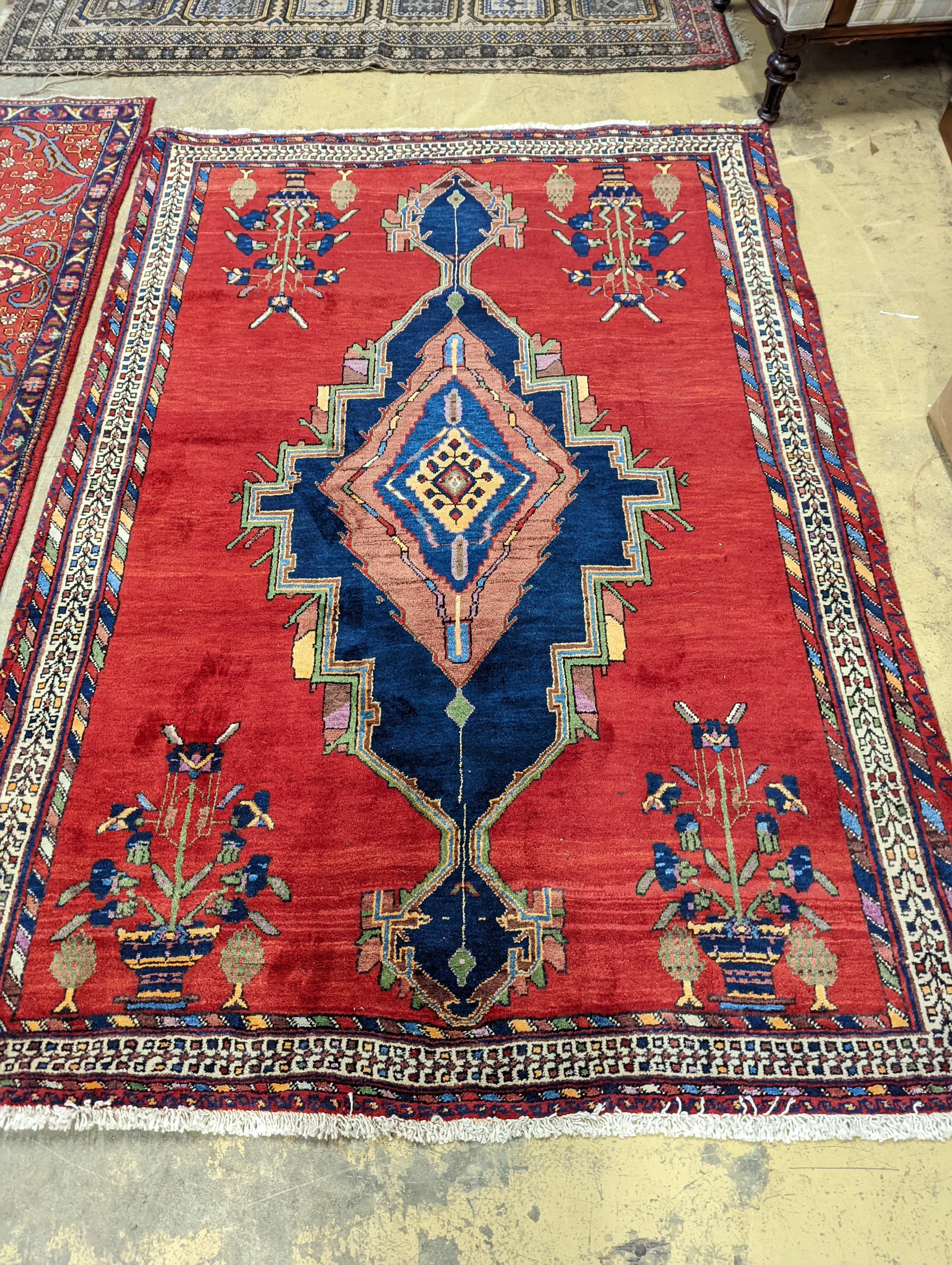 A Caucasian red ground rug, 240 x 168cm